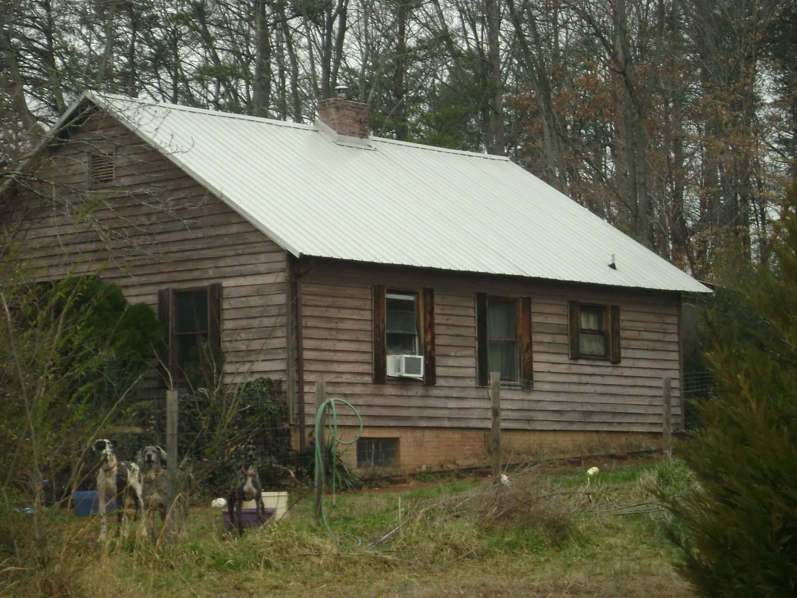 White metal roof on an old wood sided farmhouse, from a Metal Roof Installation job in Sterling